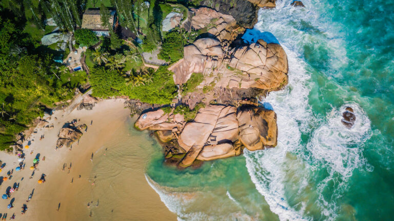 Golden oceanside sands and giant boulders on Joaquina Beach.