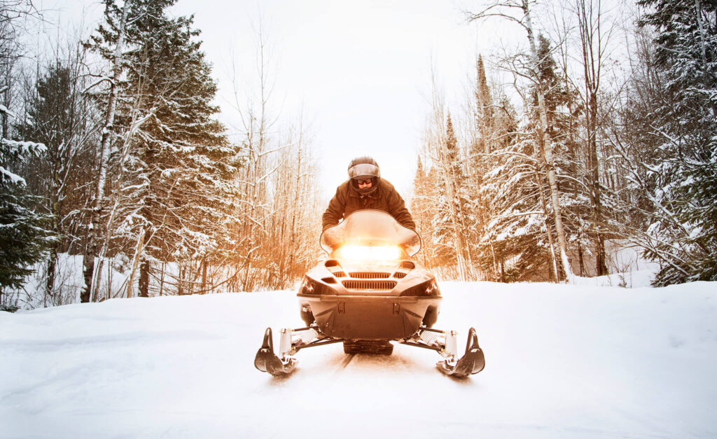 Man rides on a trail near Eagle River, the Snowmobile Capital of the World.