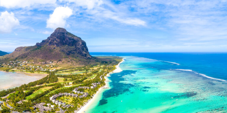 Dazzling emerald reefs extend from the Mauritius shore before melting into the blue.