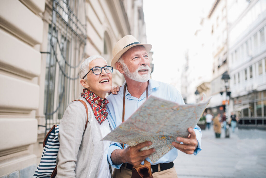 A senior couple uses a map to navigate the city.