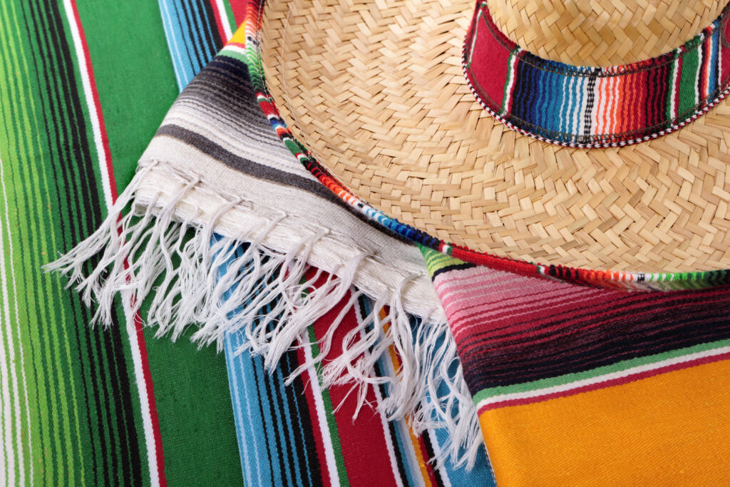 Traditional Mexican serape blankets or rugs with sombrero. Alternative file shown below: